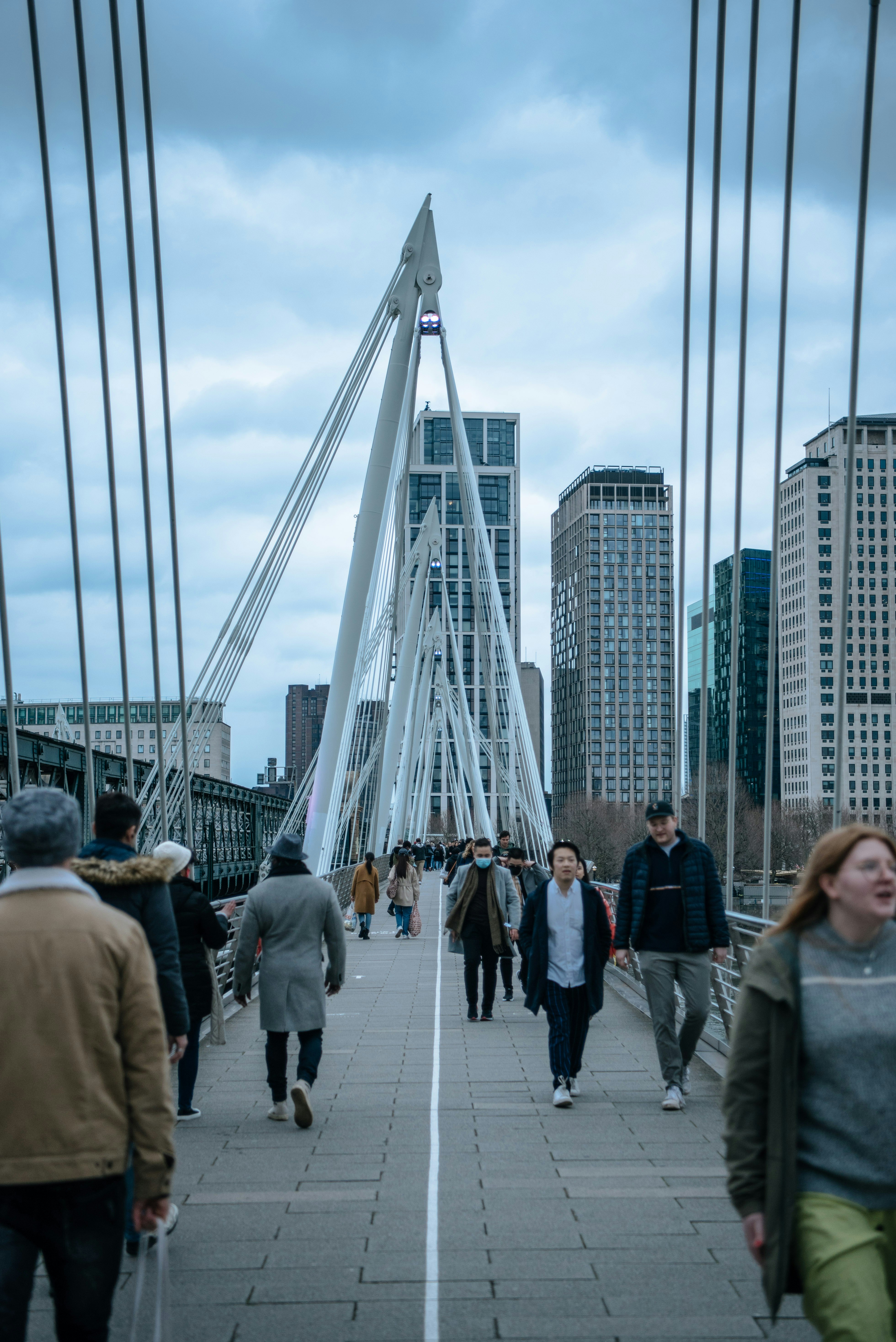 people walking on sidewalk near buildings during daytime